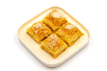 Milk baklava. Baklava with hazelnuts isolated on a white background. Mediterranean cuisine delicacies. Close-up. local name sutlu nuriye baklava