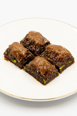 Chocolate baklava. Chocolate baklava with pistachio isolated on white background. Mediterranean cuisine delicacies. Close-up. local name cikolatali baklava