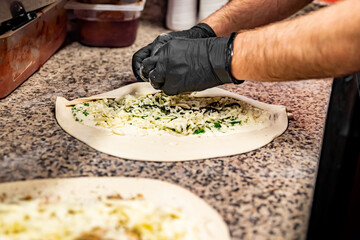 hand of chef baker making pizza at kitchen. The process of making pizza. cooking italian pizza