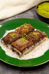 Dark chocolate baklava. Baklava with milk on a dark background. Mediterranean cuisine delicacies. Close-up. Local name bitter soguk baklava