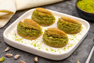 Pistachio baklava. Baklava with pistachio on a dark background. Mediterranean cuisine delicacies. Close-up. local name dilber dudagi baklava