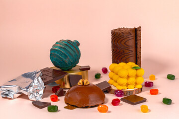 Various sweets assortment. Candy, cakes, bomb on pink background. Side view with copy space
