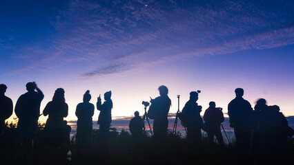 Fototapeta na wymiar Silhouette group of travel people enjoying sunset on top of mountain