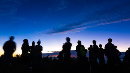 Fototapeta premium Silhouette group of travel people enjoying sunset on top of mountain