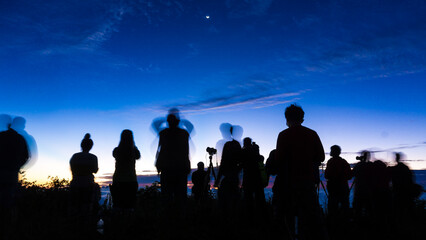Fototapeta premium Silhouette group of travel people enjoying sunset on top of mountain