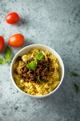Pasta with minced meat and green basil