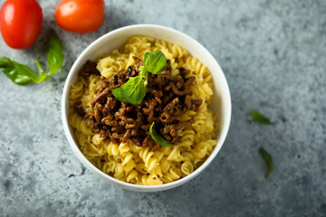 Pasta with minced meat and green basil