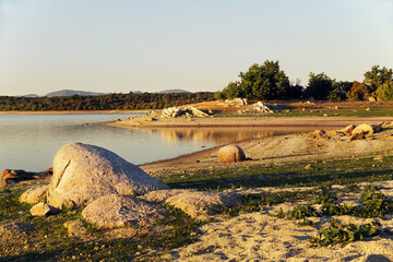 Beautiful view of Valmayor reservoir with dense vegetation in the background in Madrid, Spain