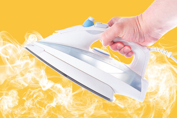 modern iron with steam in hand on yellow background