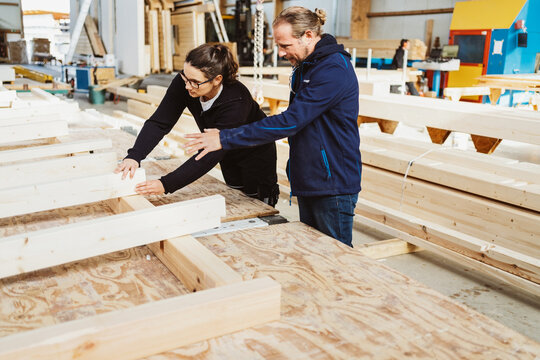 two carpenters working in the workshop on a new wooden house