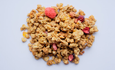 Close-up of granola, breakfast dish, snack. On the photo is a granule of oatmeal, honey and berries.