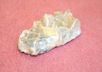 Druse of fluorite crystals on a pink background