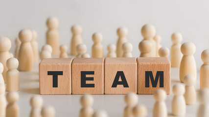 Teamwork concept, wooden dolls and wooden blocks with team words, working together for future goals.