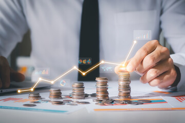Business man putting coins Business growth and investment chart, strategic planning to increase profits from doing business, long-term investment planning.