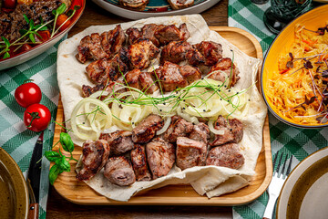 Delicious grilled pork shashlik on wooden table