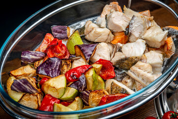 Stew with different types of fish and grilled vegetables.