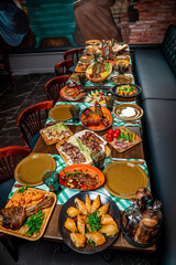 Restaurant table, many different dishes.