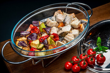 Stew with different types of fish and grilled vegetables.