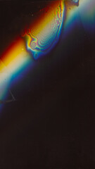 Color glitch. Stain texture. Distressed screen overlay. Blue orange white rainbow blur light leak defect dust scratches on dark black grunge abstract background.