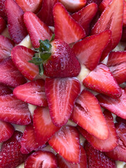 Close up shot from above of a beautiful, mouth watering shiny home made strawberry and custard cake, perfect as a snack or dessert.