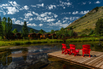 Outdoor chairs by a lake with a mountain as a backdrop in Jackson, Wyoming, USA.