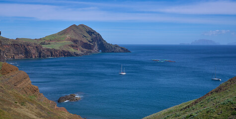Ponta de San Lorenzo, the easternmost point of the Madeira Island and a nature reserve. The island in the North Atlantic Ocean. Yachts at the foreground and the Desertas Islands at the background.
