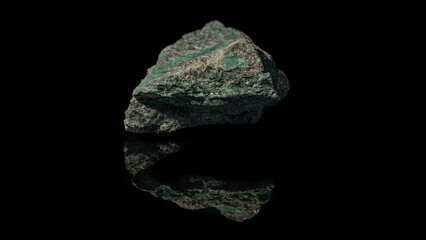 Closeup of green cuprite, copper ore mineral sample on a reflective black surface