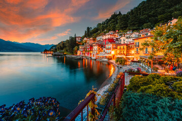 Village of Varenna on Lake Como at sunset with illuminated houses - obrazy, fototapety, plakaty