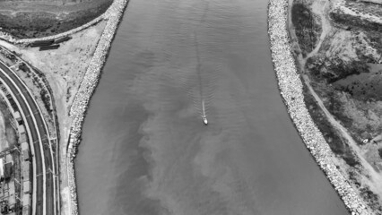 Aerial view of a little boat in the cenger of the river, Tuscany, Italy