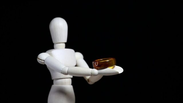 footage of wooden figure ring dark background 