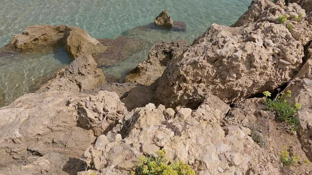 High angle view of the beautiful and crystal clear water at Lido di Noto beach, Sicily, Italy