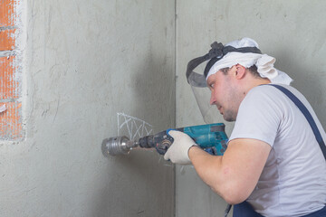 Drill a hole in the wall with a puncher for a box for mounting an electrical outlet
