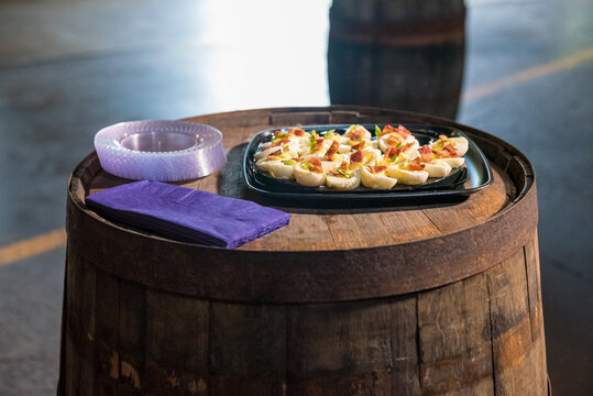 Tray Of Deviled Eggs On A Wooden Barrel In The Bar