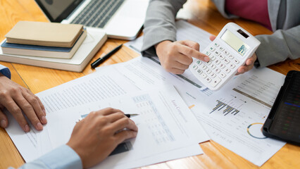 Business negotiation concept the female broker estimating the number of estate and checking it with the male broker