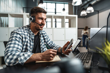Customer service support operator man with headphones and microphone talking to client in call center