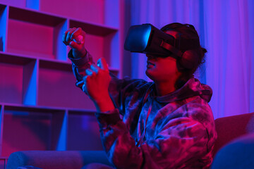 Metaverse technology concept, Man wearing VR goggles and playing car games in virtual world