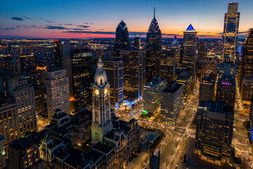 Aerial Drone View of Philadelphia Skyline at Sunset with Glowing City Lights with Town Hall in...