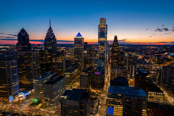 Fototapeta premium Aerial Drone View of Philadelphia Skyline at Sunset with Glowing City Lights