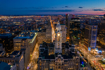 Aerial Drone View of Philadelphia Skyline at Sunset with Glowing City Lights with Town Hall in Foreground 