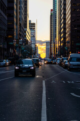 Fototapeta na wymiar Cars Driving at Sunset by Buildings in Philadelphia