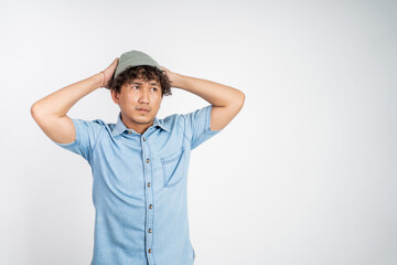 portrait of unsure asian young man thinking on isolated background