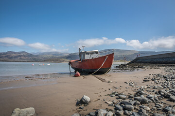 Old fishing boat Barmouth tide out