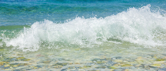 Sea wave and pebble. Summer vacation concept. Sea wave with foam incident on the coastal shingle. Travel concept