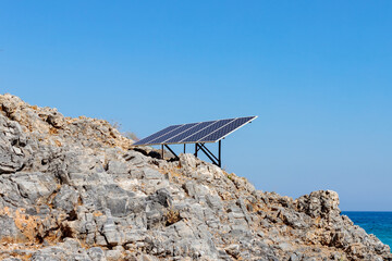 Solar panel solar cell on the rocky seashore. Source of alternative green solar energy. Concept...