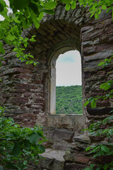 Fototapeta na wymiar ruins of an ancient castle. Arched window. Western Ukraine