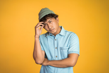 portrait of unsure asian young man thinking on isolated background