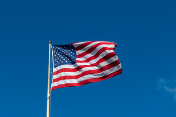 american flag on sky waving in the wind
