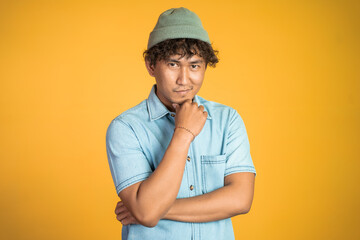 portrait of unsure asian young man thinking on isolated background