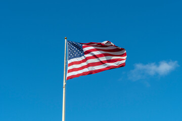 American flag in front of blue sky