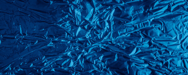 blue aluminum foil with a visible texture. background